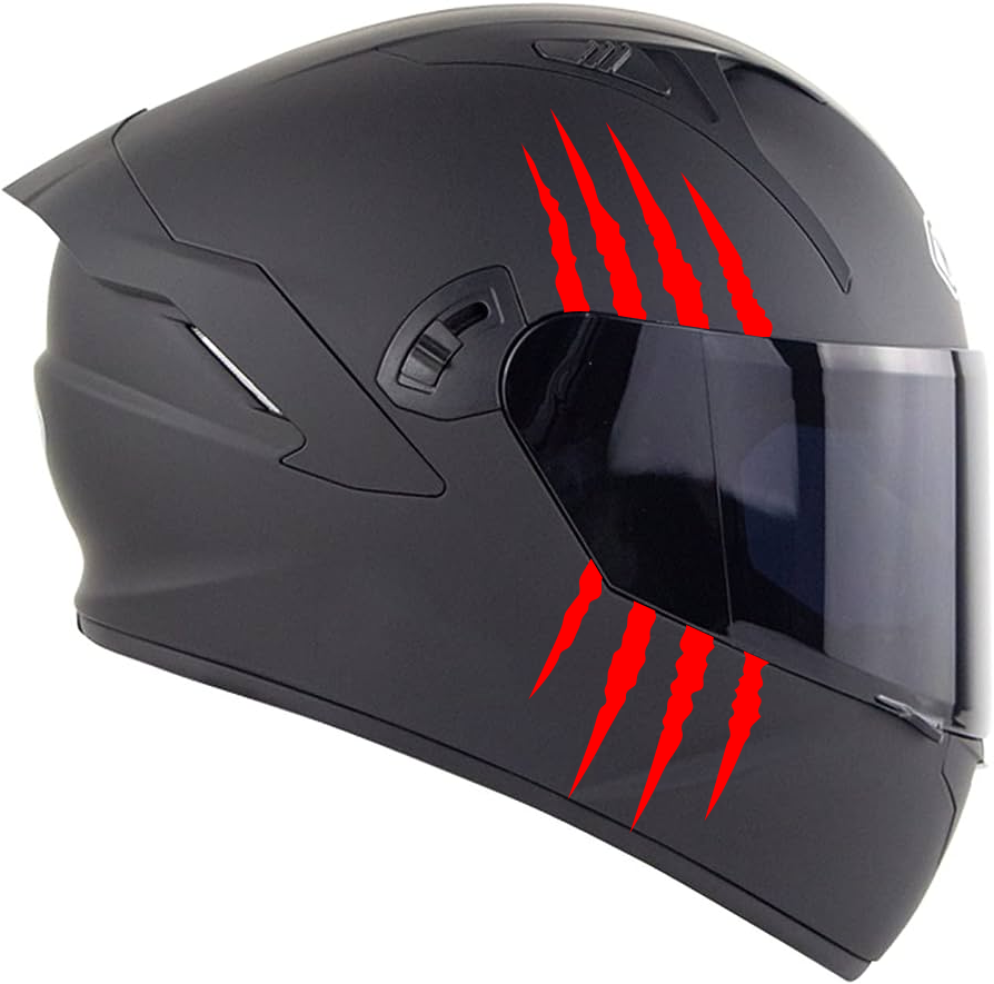 Side view of a black motorcycle helmet with claw scratch marks and visor.