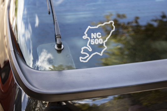 detail close-up of a white north coast 500 sticker for car windows