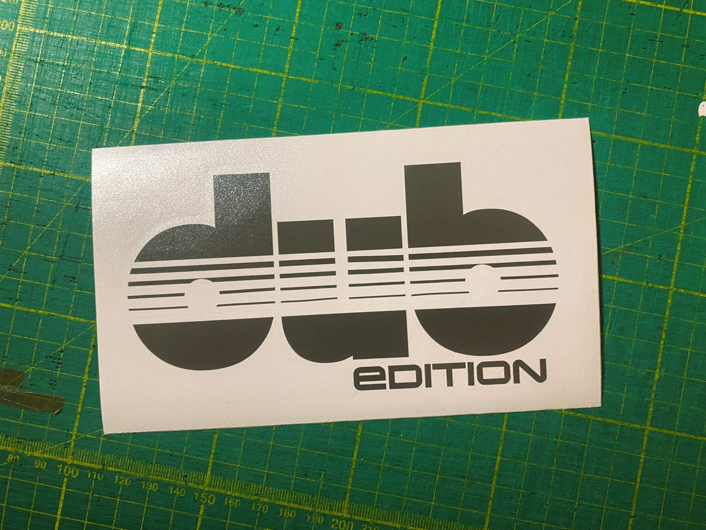 Detail close-up of the dUB Edition sticker in black and white with a flat surface